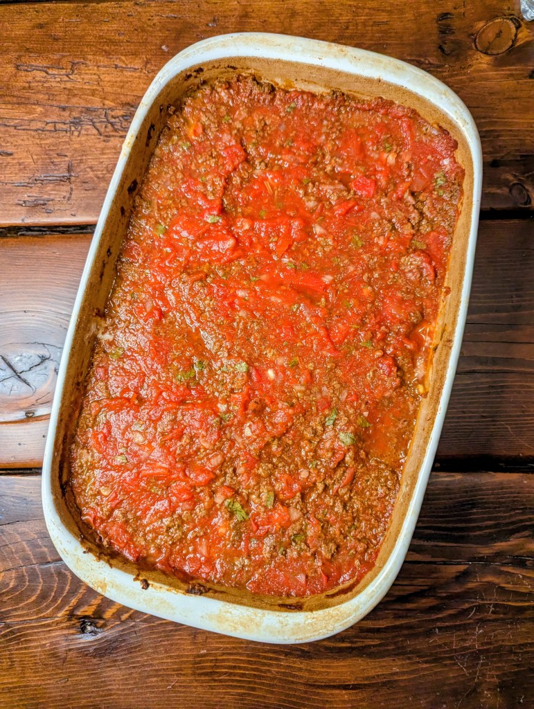 Aerial shot of a taco casserole recipe on a farmhouse table