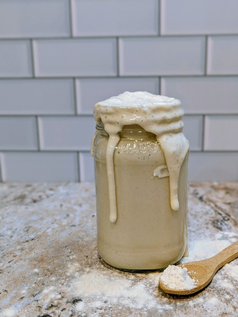 Bubbly and active sourdough starter in a glass jar